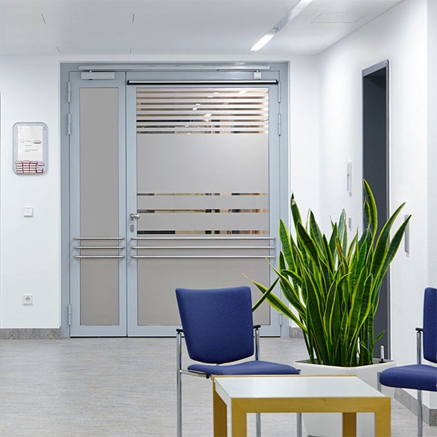 Frosted window film on a glass door and window inside a waiting room of what could be a medical center