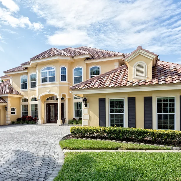 A Florida home with red tile roof has home window tinting installed on its glass.